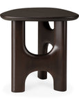 The Flow Side Table by Ethnicraft is a dark brown solid mahogany piece featuring a smooth triangular top and three thick, curved legs connected by rounded arches, beautifully channeling the essence of vintage modern furniture.