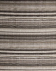 Close-up of a Zahara Outdoor Pouf in weather-resistant, woven Ethnicraft fabric featuring horizontal stripes in varying shades of beige, brown, and cream.