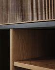 Close-up of the Oscar Drawer Unit - Teak - Black by Ethnicraft, featuring vertical slats on top and open shelving below that highlight the natural teak grain and minimalist style.