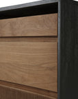 Close-up of the Ethnicraft Oscar Drawer Unit - Teak - Black, featuring a modern black frame and solid teak drawers: the upper one is smooth, while the lower drawer displays a unique textured grooved pattern.