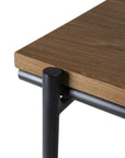 Close-up of the Oscar Desk - Teak by Ethnicraft, featuring a thick teak top and black metal legs for a minimalistic look and robust build—perfect as stylish, contemporary workspace furniture.