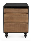 The Oscar Drawer Unit - Teak - Black by Ethnicraft is a compact wooden cabinet with three drawers—two smooth, one ribbed—set in a black frame with caster wheels, crafted from solid teak for modern style and mobility.