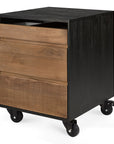 The Oscar Drawer Unit - Teak - Black by Ethnicraft is a modern, minimalist drawer unit with three drawers—one ribbed—crafted from solid teak and black accents, set on four caster wheels for easy mobility.