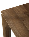 Close-up of the Ethnicraft Bok Extendable Dining Table in Natural Teak, highlighting its smooth surface, visible natural wood grain, and sturdy leg design against a white background—ideal for stylish dining spaces.