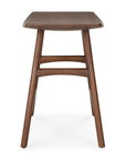 The Ethnicraft Osso Dining Stool features four angled legs, a rectangular seat, and two support bars, all crafted from smooth, dark brown FSC-certified teak.