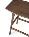 Close-up of the Osso Counter Stool - Teak by Ethnicraft, featuring FSC-certified teak, tapered legs, and a smooth dark brown finish, photographed against a white background.
