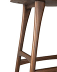 Close-up of the Osso Barstool - Teak by Ethnicraft, featuring FSC-certified teak with a smooth finish, elegant curved legs, and intersecting supports for added style and stability.