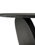 Close-up view of the edge and base of the Oblic Side Table - Black by Ethnicraft, featuring FSC-certified dark teak and a smooth, curved modern design against a white background.