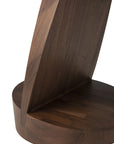 Close-up of the Oblic Side Table - Teak by Ethnicraft, showing a vertical angled slab joined to a round flat base, both crafted from smooth, dark brown FSC-certified teak.