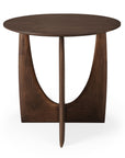 The Ethnicraft Geometric Side Table features a modern round design in varnished teak with a smooth top and unique base, including two curved legs and a central vertical support, all in a dark wood finish.