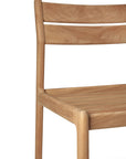 A close-up of the Ethnicraft Jack Outdoor Dining Chair - Teak (without armrest) showcases its minimalist design, curved backrest, smooth rounded edges, and visible natural teak wood grain.