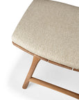 A close-up of the Osso Outdoor Stool with cushion by Ethnicraft, featuring angled wooden legs and a light beige textured fabric seat, photographed against a white background.