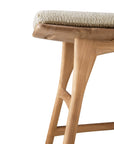 Close-up of the Ethnicraft Osso Outdoor Stool with light teak wood legs and a cushioned seat in textured beige fabric, shown against a white background.
