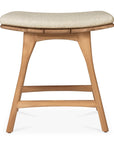 The Ethnicraft Osso Outdoor Stool with cushion features curved teak legs and a light beige upholstered seat, shown from the front against a plain white background.