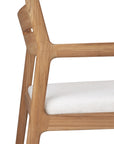 Close-up of the Ethnicraft Jack Outdoor Dining Chair - Teak, featuring angular legs and armrest in solid teak, with a light, textured outdoor fabric seat cushion for classic European refinement.