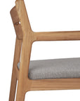 Close-up of the Ethnicraft Jack Outdoor Dining Chair - Teak (with armrest), showcasing its modern solid teak frame with an angular design and light gray upholstered seat cushion.