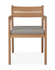 The Jack Outdoor Dining Chair - Teak by Ethnicraft features a classic European-inspired design with a natural teak finish, armrests, straight backrest, and a light gray upholstered seat, photographed against a white background.