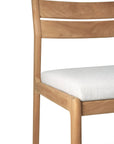 The Ethnicraft Jack Outdoor Dining Chair - Teak (without armrest) features a light solid teak frame with a curved backrest and white outdoor fabric seat, offering modern style and comfort.