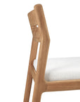 A close-up side view of the Ethnicraft Jack Outdoor Dining Chair - Teak (without armrest), featuring solid teak with a light wood finish and a white upholstered seat, highlights its simple lines and refined craftsmanship.