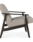 The Ethnicraft Aspekt Lounge Chair features dark brown teak legs and armrests, light gray upholstery, and a modern silhouette, shown from the side against a white background.