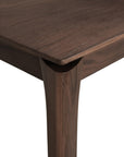 Close-up of the Ethnicraft Bok Dining Table - Brown Teak, highlighting its FSC-certified solid teak, smooth finish, natural wood grain, and subtly rounded leg design. Set against a plain white background.