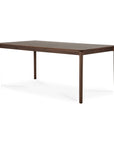 The Ethnicraft Bok Dining Table - Brown Teak is a rectangular table crafted from FSC certified solid teak with four straight legs and a dark brown finish, displayed on a white background.