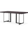 The Tacet Dining Table by Ethnicraft features a modern rectangular design with a dark teak top and black metal sled legs, displayed against a white background.