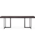 The Ethnicraft Tacet Dining Table features a modern rectangular design with a dark teak top and two black metal sled-style legs, shown from the front against a white background.