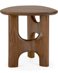 The Flow Side Table by Ethnicraft is a compact, solid mahogany piece featuring a sleek, rounded triangular top and three substantial curved legs with cut-out arches, all finished in a rich dark brown—ideal for introducing vintage modern style to any space.