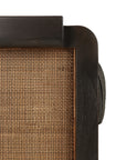 Close-up of the Ethnicraft Panel Lounge Chair - Dark Brown Teak, showcasing woven rattan detailing, rounded dark wood edges, and a partial view of a cylindrical cushion on the right.
