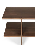 Angled view of the Kabuki Side Table by Ethnicraft, crafted from varnished teak with two rectangular shelves and a vertical center support in dark wood, shown against a white background.