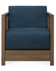 The Roan Lounge Chair | Ink by Ethnicraft is a modern armchair featuring a wooden frame and blue upholstered seat and backrest, presented from the front against a white background. Vintage-inspired, this chair effortlessly combines classic elegance with contemporary design.
