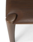 Close-up view of the Ethnicraft Pi Bench in teak, highlighting its smooth, rounded edges and seamless joint between leg and top, crafted with classic European refinement.