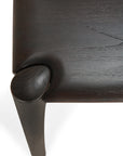Close-up of the Ethnicraft PI Dining Table - Teak Dark Brown, featuring a smoothly sculpted solid teak leg with visible wood grain and fine craftsmanship, set against a white background.