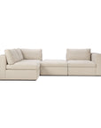 The Ethnicraft Mellow Modular Sofa in Off White is a modern, L-shaped sofa with thick cushions, armrests, stain-resistant Italian fabric, two corner seats, a central ottoman, and two loose back pillows.