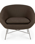 Dark brown rounded Ethnicraft Barrow Lounge Chair - Paon with a thick seat cushion on a slim, crossed metal base.