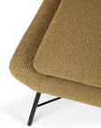 Close-up of the Ethnicraft Barrow Footstool in Ginger, featuring textured fabric, angled lines, black metal legs, and a minimalist design inspired by vintage furniture, shown against a white background.