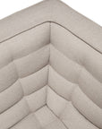 A close-up view of the corner of the N701 2-Seater Sofa in beige by Ethnicraft highlights its textured, tufted fabric and quilted cushion design, showcasing exceptional European craftsmanship.