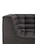 Close-up of the N701 3 Seater Sofa in Dark Grey by Ethnicraft, displaying its modern, boxy silhouette and quilted, grid-patterned seat and back cushions. Featuring distinct European design elements from Ethnicraft, only one corner of the sofa is visible.