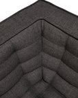Close-up of the corner of the Ethnicraft N701 2-Seater Sofa in Dark Grey, featuring visible stitching and a textured fabric surface that accentuates its refined European design.