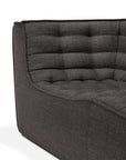 Close-up of the Ethnicraft N701 3-Seater Sofa in dark grey fabric, featuring a quilted, tufted backrest and seat cushion that highlight its elegant European design, photographed against a white background.