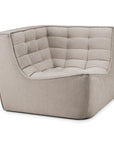The Ethnicraft N701 Modular Sofa - Ecru (Eco Fabric) features a modern, tufted cushion design with soft, rounded edges. This low-profile, light beige corner piece is perfect for lounging and adds versatility to any living space.