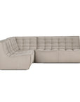 The N701 Modular Sofa by Ethnicraft in ecru eco fabric features tufted seat and back cushions, soft recycled cotton upholstery, low rounded armrests, and a stain-resistant, minimalist design that sits directly on the floor.