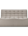 The Ethnicraft N701 Modular Sofa in Ecru Eco Fabric features a modern, stain-resistant quilted design with tufting and a low, curved backrest, shown against a white background.