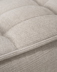 Close-up of the Ethnicraft N701 Modular Sofa in Ecru Eco Fabric, showing its light beige, textured, stain-resistant upholstery with visible stitching and a grid-like tufted pattern.