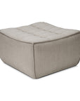 The Ethnicraft N701 Modular Sofa in ecru eco fabric features a square, light gray form with a soft, tufted top and rounded edges—upholstered in stain-resistant, textured fabric for a stylish sectional accent.