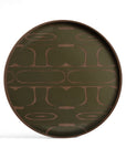 The Second Nature Valet Tray by Ethnicraft is a round tray with a raised edge, featuring dark olive green silk-screen printed glass with abstract, symmetrical brown patterns.