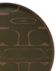 A partial view of the Ethnicraft Second Nature Valet Tray reveals an abstract geometric pattern in olive green and wood tones, with curved, oval shapes forming a symmetrical design.