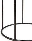 A close-up of the black metal base of an Ethnicraft Round Tray Side Table, featuring three vertical legs joined by a circular ring for a sleek, customizable design.