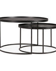 The Ethnicraft Tray Coffee Table Set of 2 features round, black metal tables with thin frames and flat tops. The smaller table tucks under the larger, showcasing their modern nesting design as part of the Ethnicraft collection.